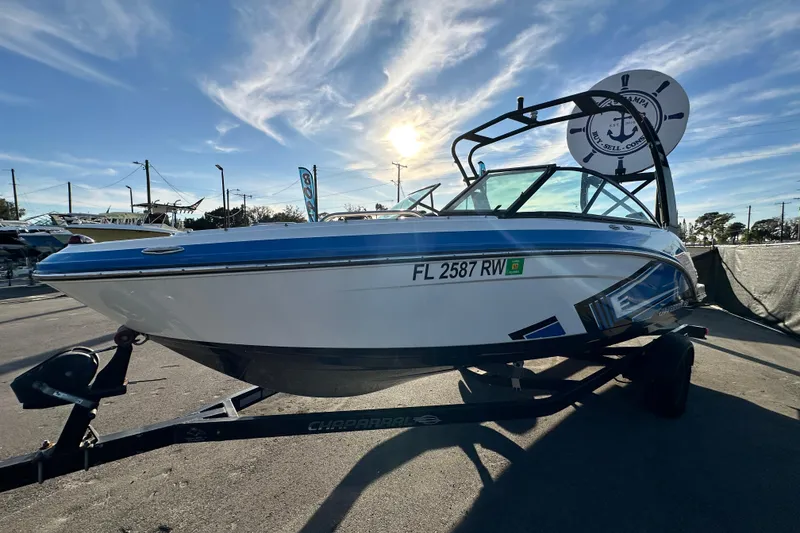 Slide: The Image of 2019 Chaparral Vortex 2430 VRX boat on trailer under clear sky. - 8