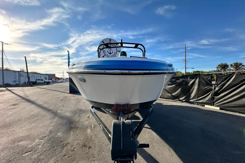 Slide: The Image of 2019 Chaparral Vortex 2430 VRX boat on trailer under clear blue sky. - 9