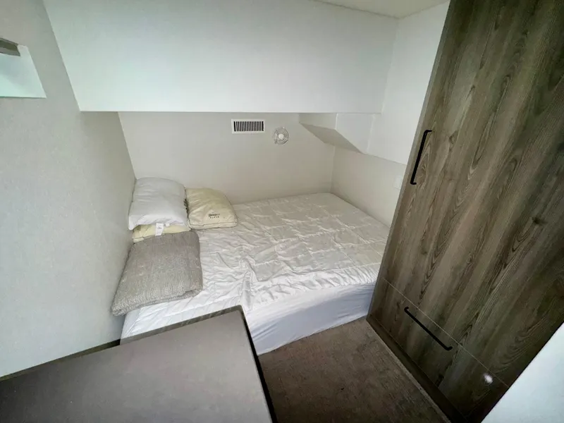 Slide: The Image of Compact bedroom in Adonia Obsession Share Trip #9, 2021 model, featuring a cozy bed and wooden wardrobe. - 10