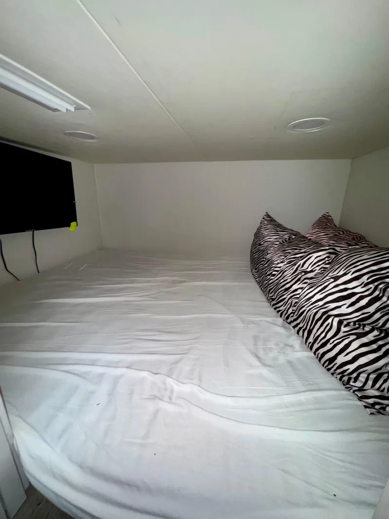Slide: The Image of Compact sleeping area in Adonia Obsession Share Trip #9, 2021, with zebra-patterned pillows. - 11