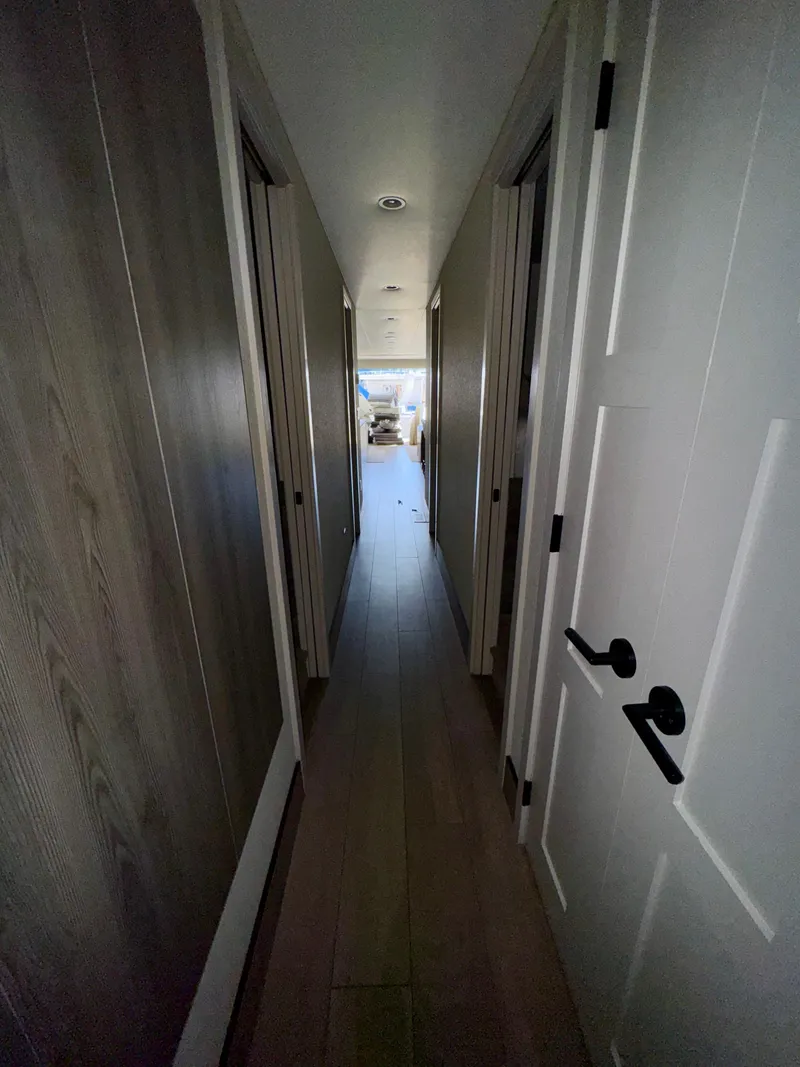 Slide: The Image of Narrow hallway in Adonia Obsession Share Trip #9, 2021 model, with wooden doors and flooring. - 15
