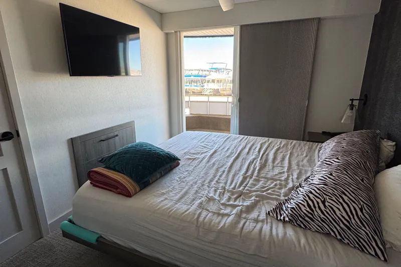 Slide: The Image of Modern bedroom with zebra print pillow, wall-mounted TV, and balcony view on Adonia Obsession Share Trip #9. - 18