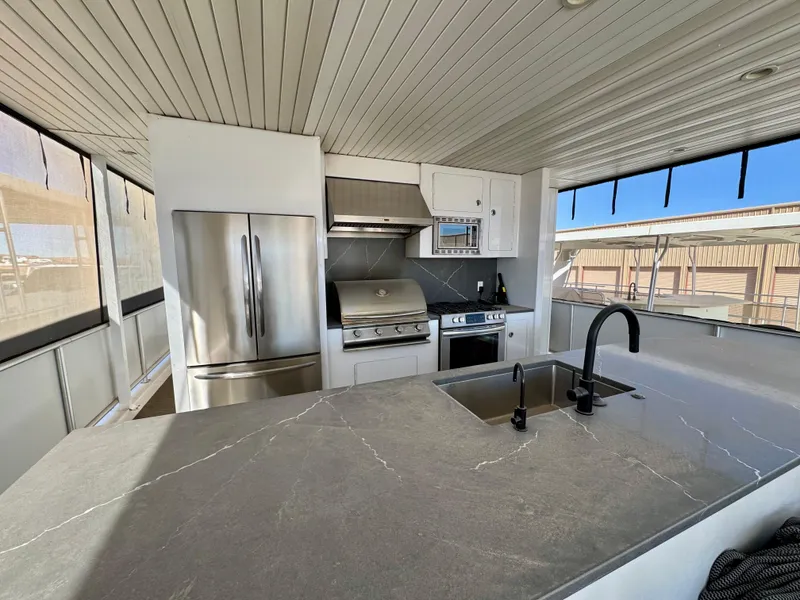 Slide: The Image of Modern kitchen on Adonia Obsession Share Trip #9 houseboat, featuring stainless steel appliances and sleek countertops. - 27