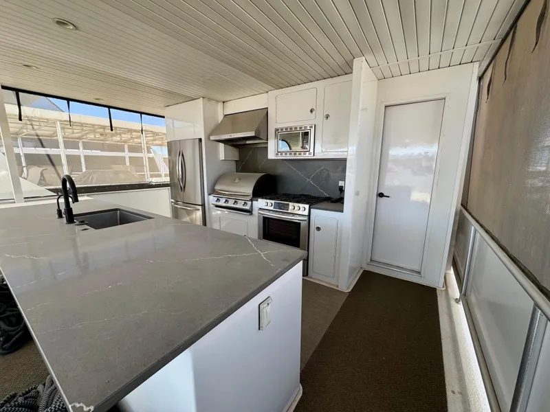 Slide: The Image of Modern kitchen on Adonia Obsession Share Trip #9 houseboat, featuring stainless steel appliances and sleek countertops. - 28