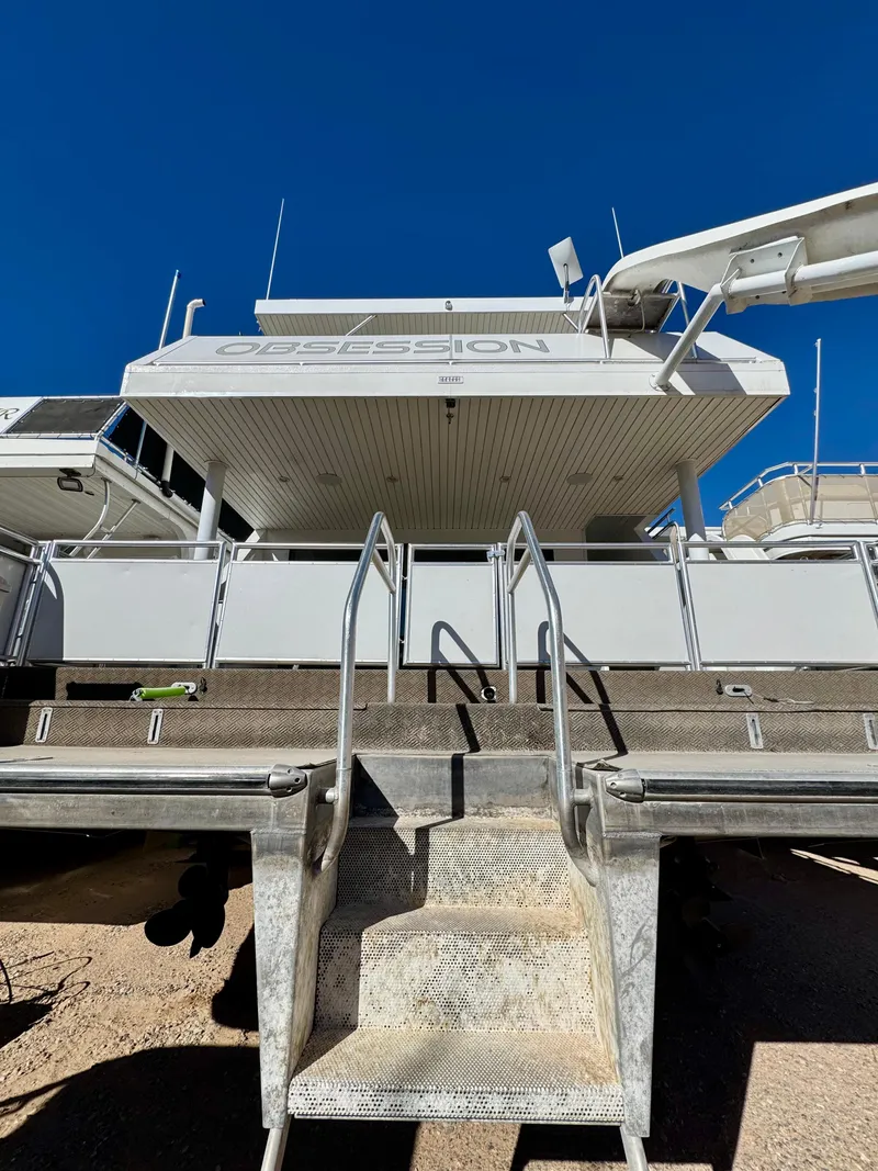 Slide: The Image of Adonia Obsession Share Trip #9 boat, 2021 model, viewed from the rear with clear blue sky. - 36