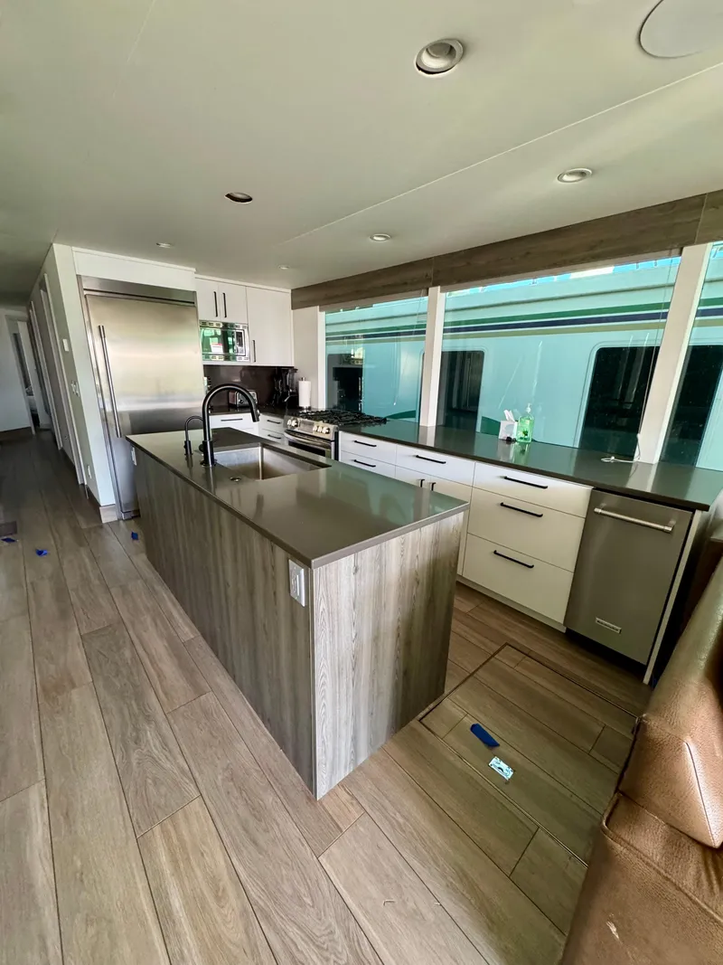 Slide: The Image of Modern kitchen interior in 2021 Adonia Obsession Share Trip #9 RV, featuring sleek countertops and appliances. - 6
