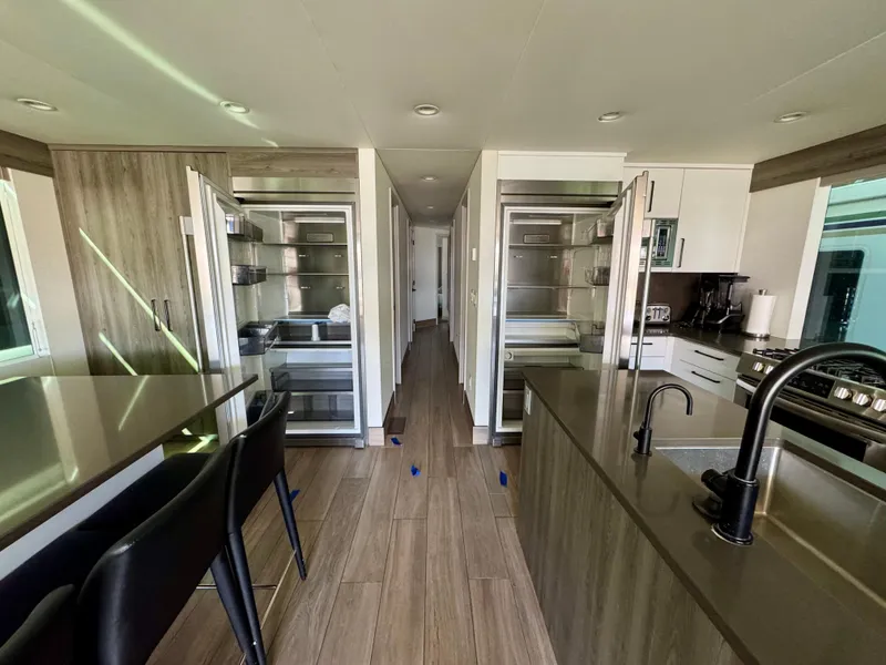 Slide: The Image of Modern kitchen interior in Adonia Obsession Share Trip #9, 2021 model, featuring sleek appliances and wood flooring. - 8