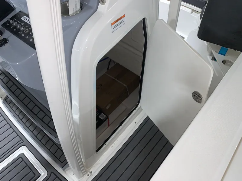 Slide: The Image of 2024 Bayliner Trophy 20CC storage compartment with open door. - 8