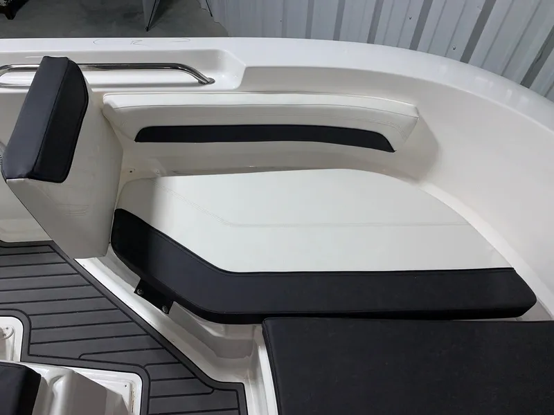 Slide: The Image of 2024 Bayliner Trophy 20CC boat interior seating with black and white cushions. - 13