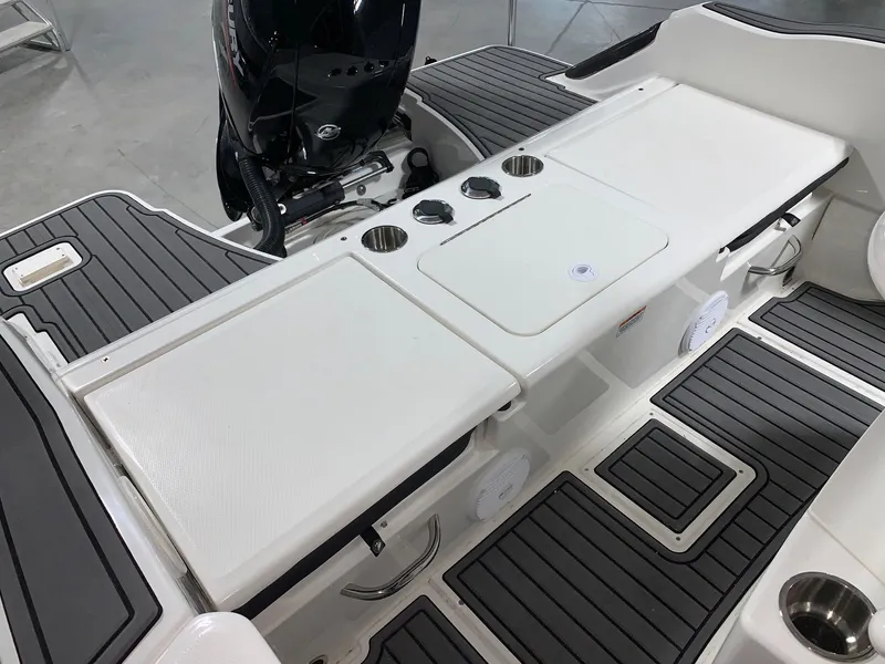 Slide: The Image of 2024 Bayliner Trophy 20CC boat deck with motor and storage compartments. - 5