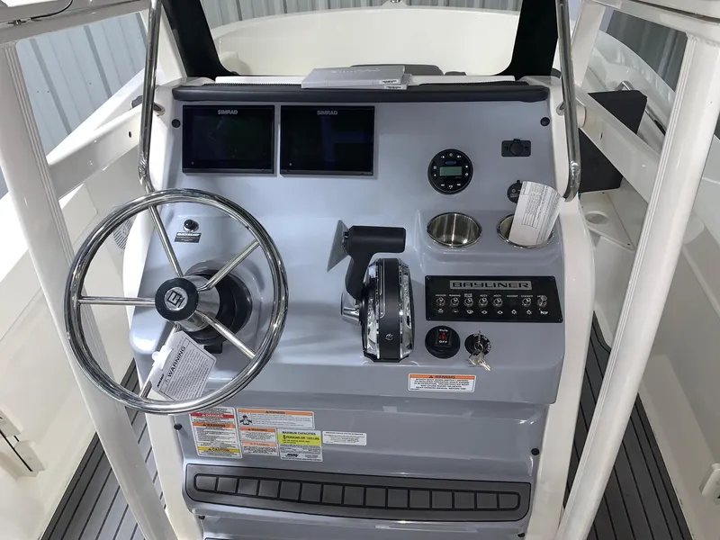 Slide: The Image of 2024 Bayliner Trophy 20CC boat console with steering wheel and control panel. - 7