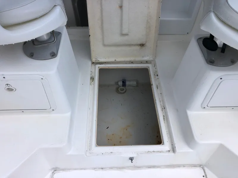 Slide: The Image of Open storage compartment on 2000 Cobia 240 Walk-Around boat deck. - 17