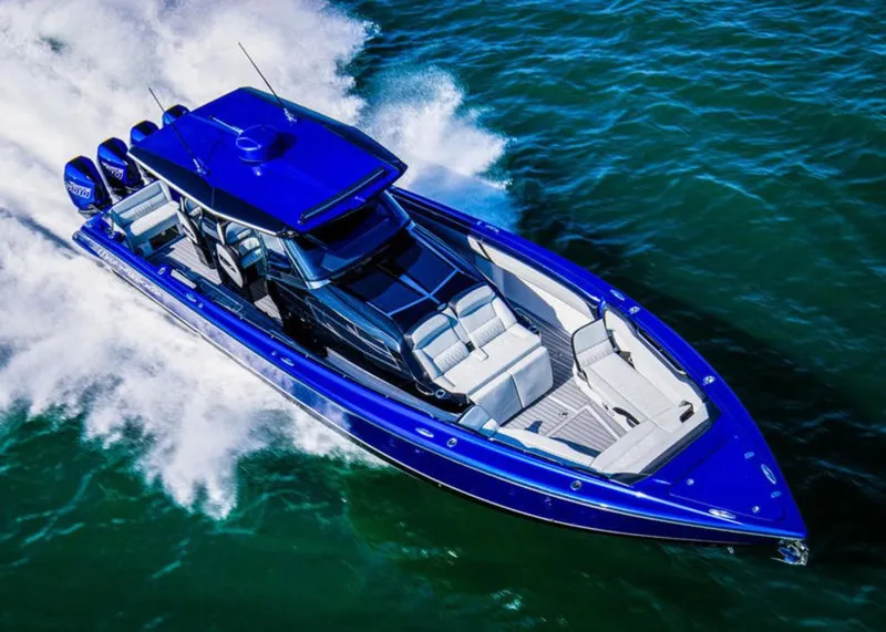 Slide: The Image of 2025 Nor-Tech 450 Sport boat cruising on open water, vibrant blue exterior. - 1