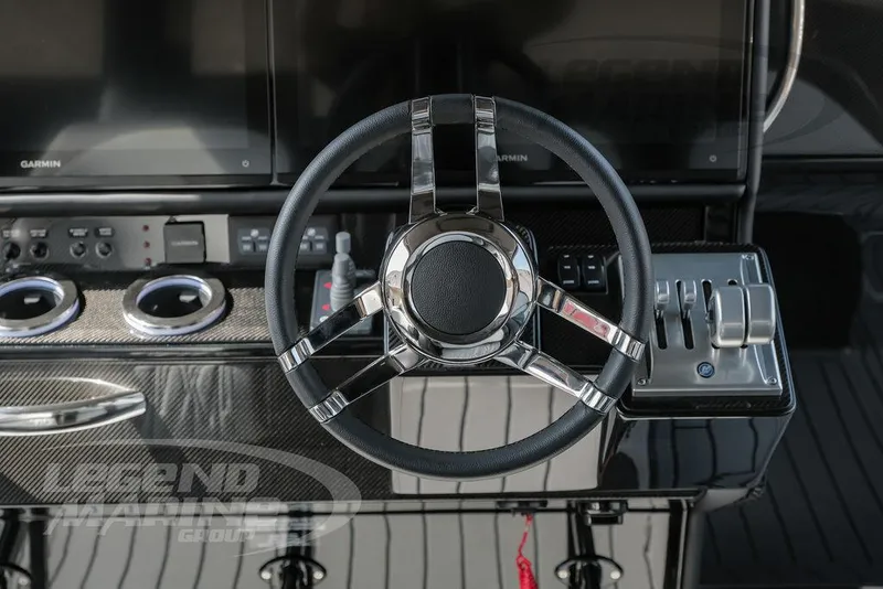 Slide: The Image of Steering wheel and controls of 2025 Nor-Tech 450 Sport boat cockpit. - 13
