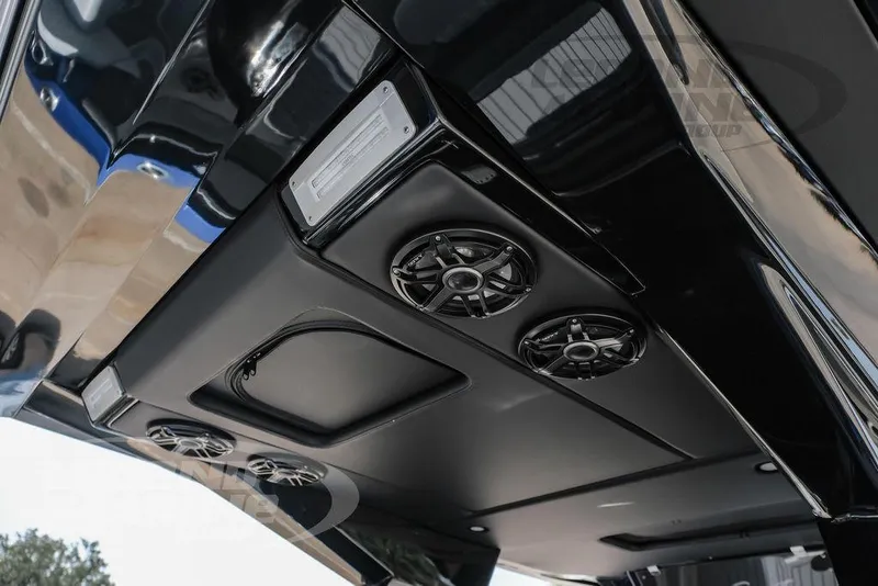 Slide: The Image of 2025 Nor-Tech 450 Sport boat interior ceiling with speakers and sleek design. - 19