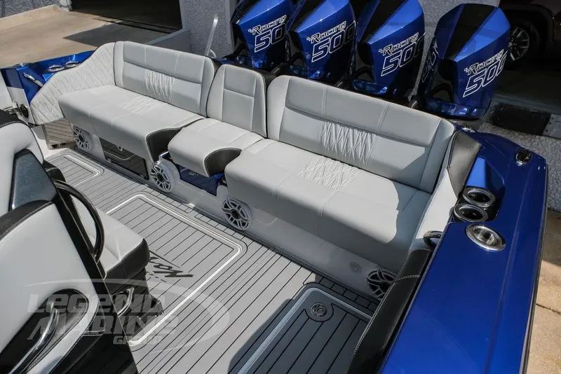 Slide: The Image of 2025 Nor-Tech 450 Sport boat interior with seating and powerful outboard engines. - 28