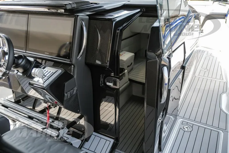 Slide: The Image of Interior view of 2025 Nor-Tech 450 Sport boat, featuring sleek black design and modern controls. - 46