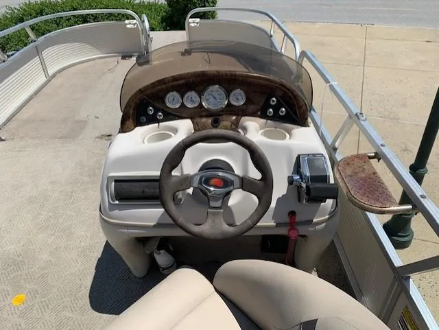 Slide: The Image of 2008 Sun Tracker Party Barge 24 boat helm with steering wheel and control panel. - 5