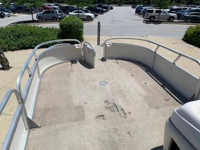 Slide: The Image of 2008 Sun Tracker Party Barge 24 pontoon boat deck in a parking lot. - 6