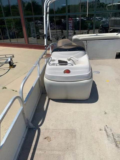 Slide: The Image of 2008 Sun Tracker Party Barge 24 pontoon boat docked near a building. - 7