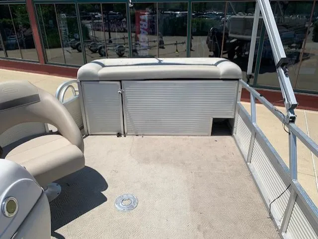 Slide: The Image of 2008 Sun Tracker Party Barge 24 interior with beige seating and spacious deck. - 8