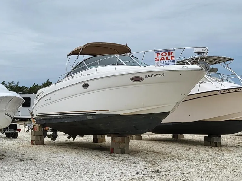 The Image of 2001 Sea Ray 290 Amberjack boat for sale, displayed on blocks. - 0