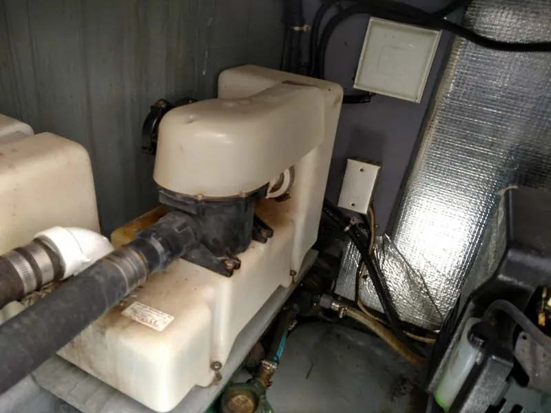 Slide: The Image of Engine compartment of a 2001 Sea Ray 290 Amberjack boat, showing mechanical components. - 17