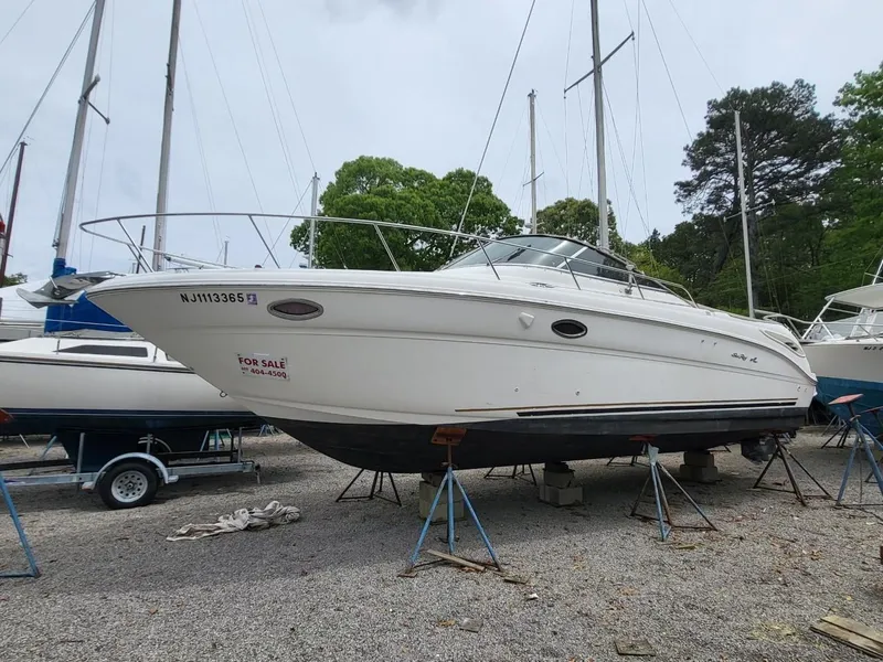 Slide: The Image of 2001 Sea Ray 290 Amberjack boat on stands, for sale in a boatyard. - 18