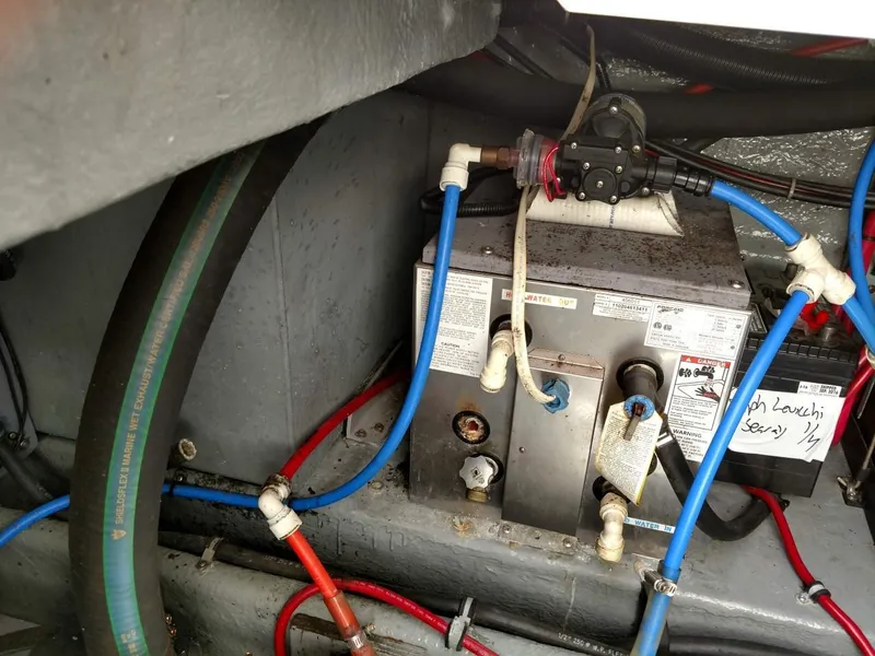 Slide: The Image of Engine compartment of a 2001 Sea Ray 290 Amberjack with visible plumbing and wiring. - 20