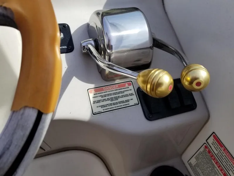 Slide: The Image of Throttle controls on a 2001 Sea Ray 290 Amberjack boat dashboard. - 27