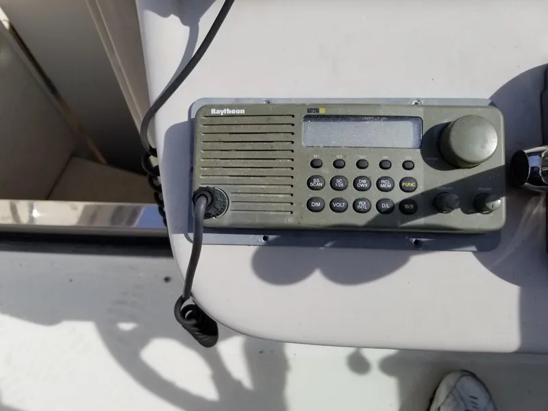 Slide: The Image of Raytheon marine radio on 2001 Sea Ray 290 Amberjack boat dashboard. - 28