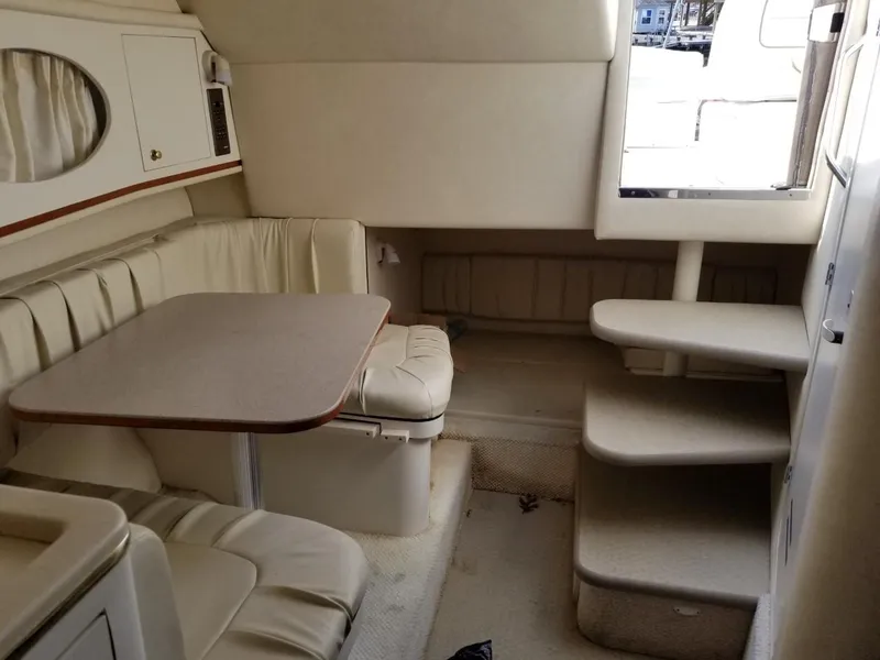 Slide: The Image of 2001 Sea Ray 290 Amberjack cabin interior with seating and table. - 30