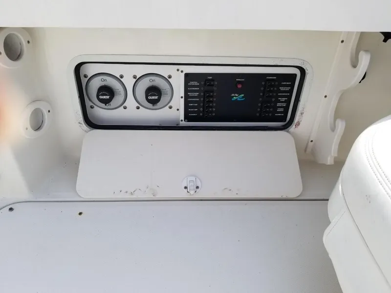 Slide: The Image of Control panel of a 2001 Sea Ray 290 Amberjack boat, featuring switches and gauges. - 32