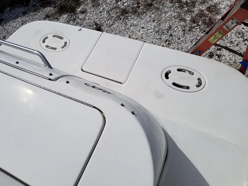 Slide: The Image of 2001 Sea Ray 290 Amberjack boat deck with storage hatches and railing. - 33