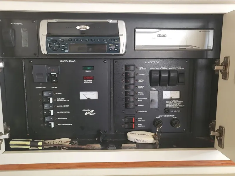 Slide: The Image of Control panel of a 2001 Sea Ray 290 Amberjack boat with stereo and electrical switches. - 37