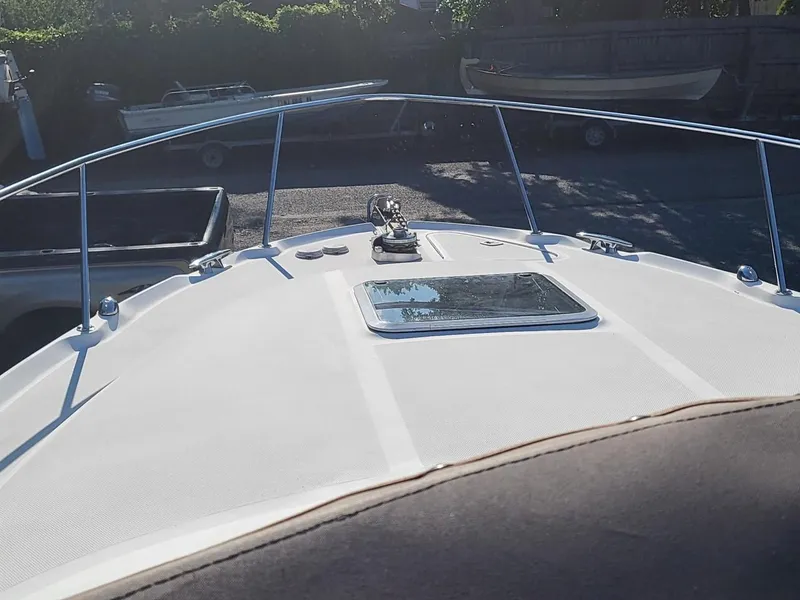 Slide: The Image of 2001 Sea Ray 290 Amberjack boat deck with railing and hatch. - 38