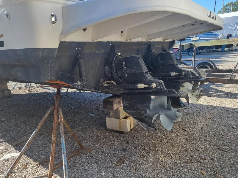 Slide: The Image of 2001 Sea Ray 290 Amberjack boat on stands, showing dual propellers and stern drive. - 39