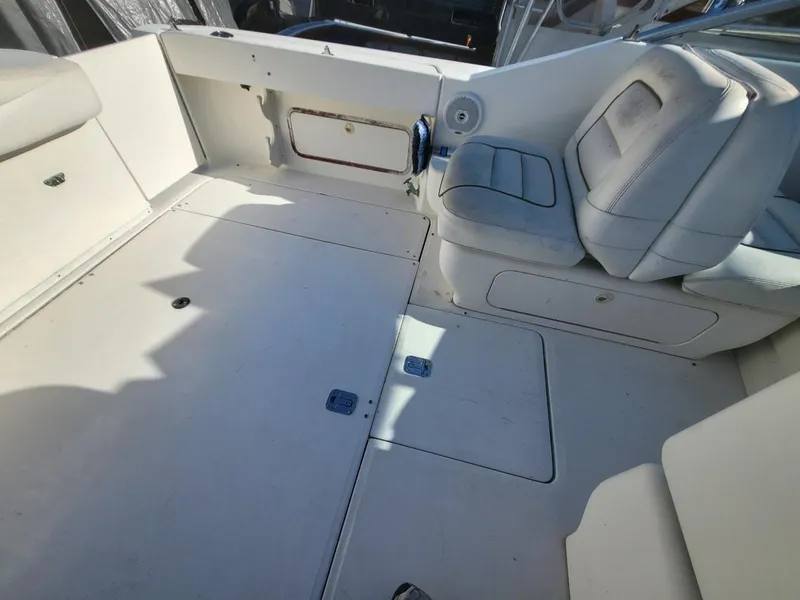 Slide: The Image of 2001 Sea Ray 290 Amberjack boat interior with white seating and spacious deck area. - 45