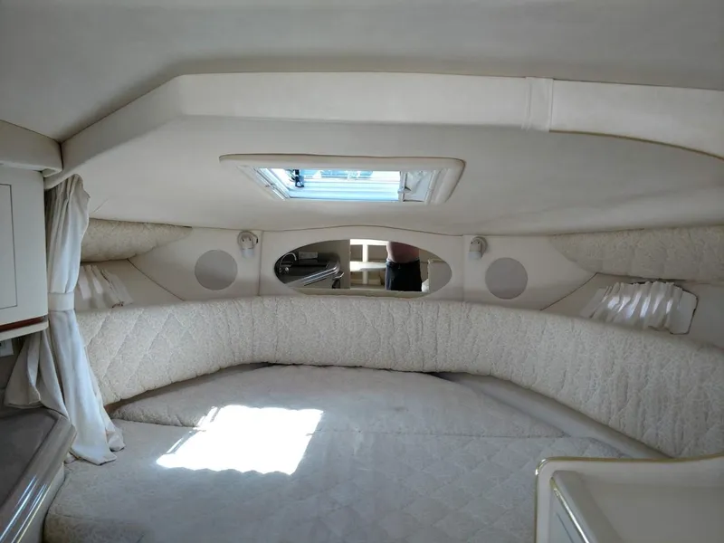 Slide: The Image of Interior cabin of 2001 Sea Ray 290 Amberjack boat, featuring a cozy sleeping area. - 6