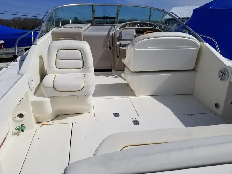 Slide: The Image of 2001 Sea Ray 290 Amberjack boat interior with white seating and steering console. - 7