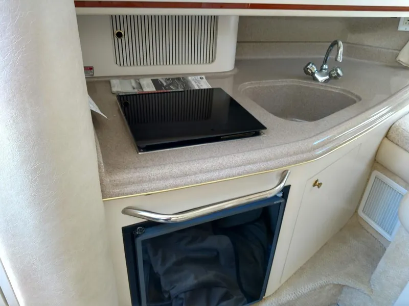 Slide: The Image of 2001 Sea Ray 290 Amberjack boat interior with kitchenette and sink. - 8