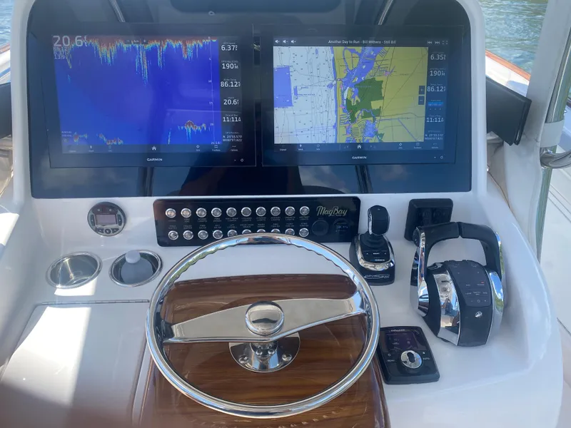 Slide: The Image of 2019 Mag Bay Center Console dashboard with navigation screens and controls. - 3