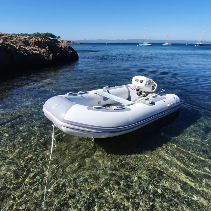 The Image of 2024 Zodiac Cadet Aero 310 inflatable boat anchored in clear, shallow water. - 1
