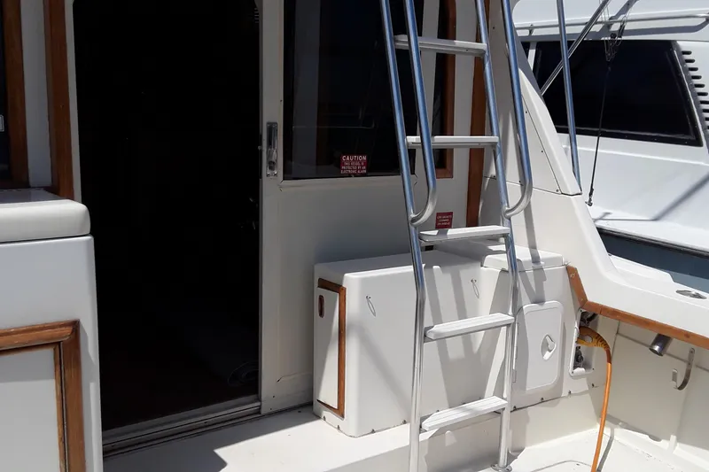 Slide: The Image of 1987 Blackfin 36 Convertible boat with ladder and open cabin door. - 11