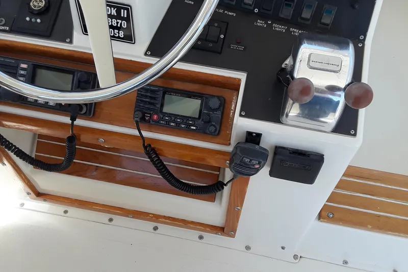 Slide: The Image of 1987 Blackfin 36 Convertible boat helm with steering wheel and control panel. - 12