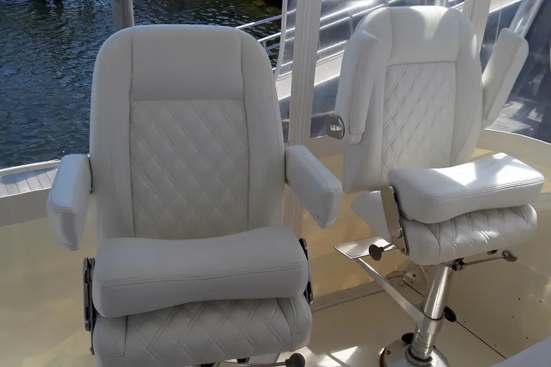 Slide: The Image of Two white captain's chairs on a 1987 Blackfin 36 Convertible boat. - 13