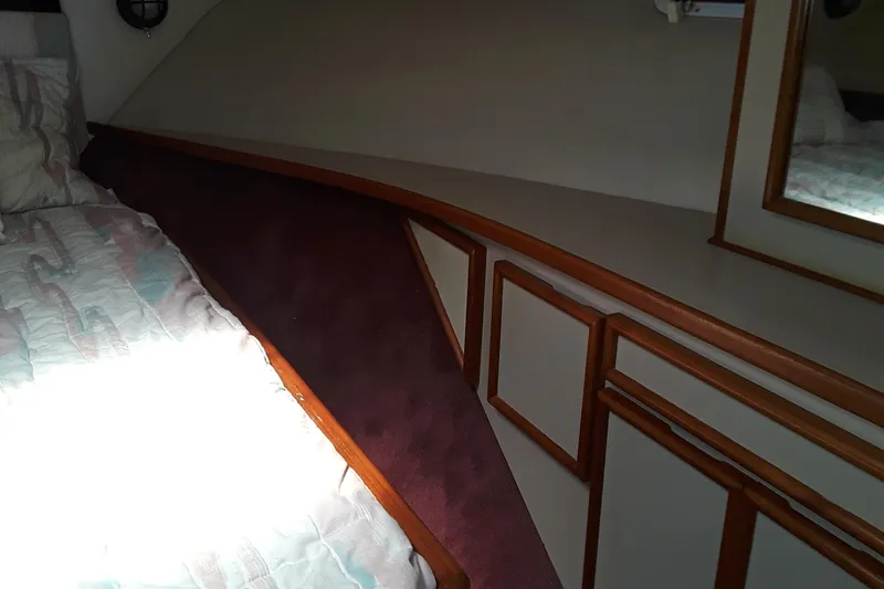 Slide: The Image of Interior cabin of 1987 Blackfin 36 Convertible boat with bed and wooden cabinetry. - 24