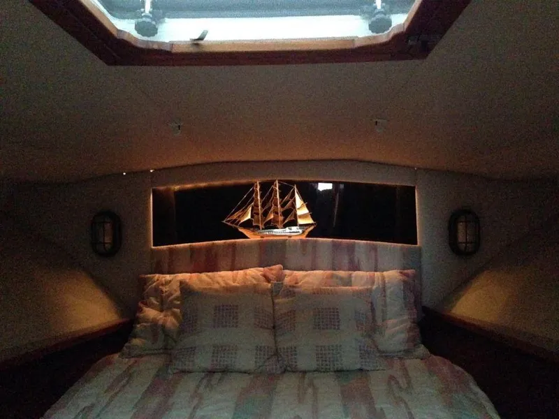 Slide: The Image of Interior cabin of 1987 Blackfin 36 Convertible boat with bed and model ship. - 26