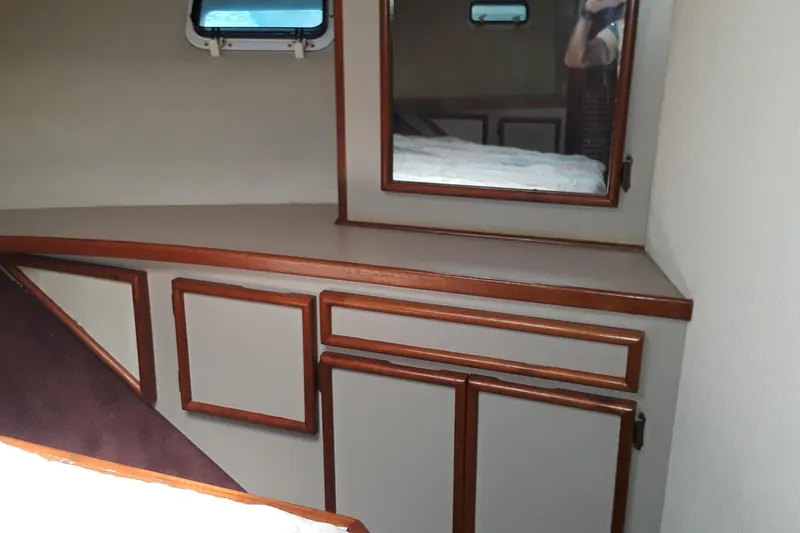 Slide: The Image of 1987 Blackfin 36 Convertible cabin interior with wooden trim and storage cabinets. - 28
