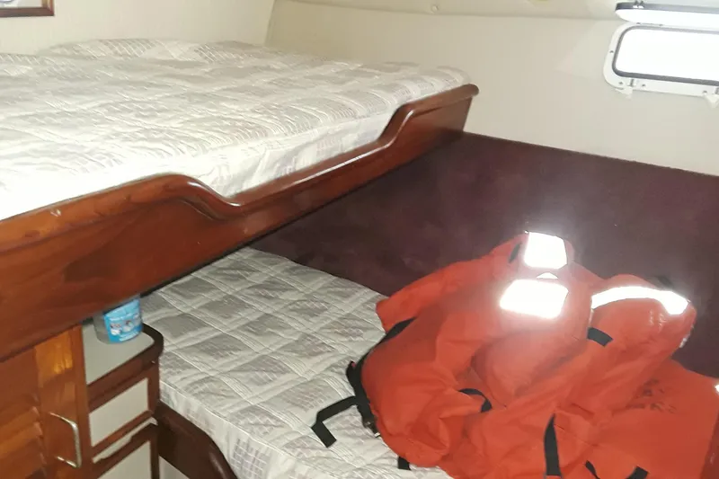 Slide: The Image of 1987 Blackfin 36 Convertible cabin with bunk beds and life jackets. - 31